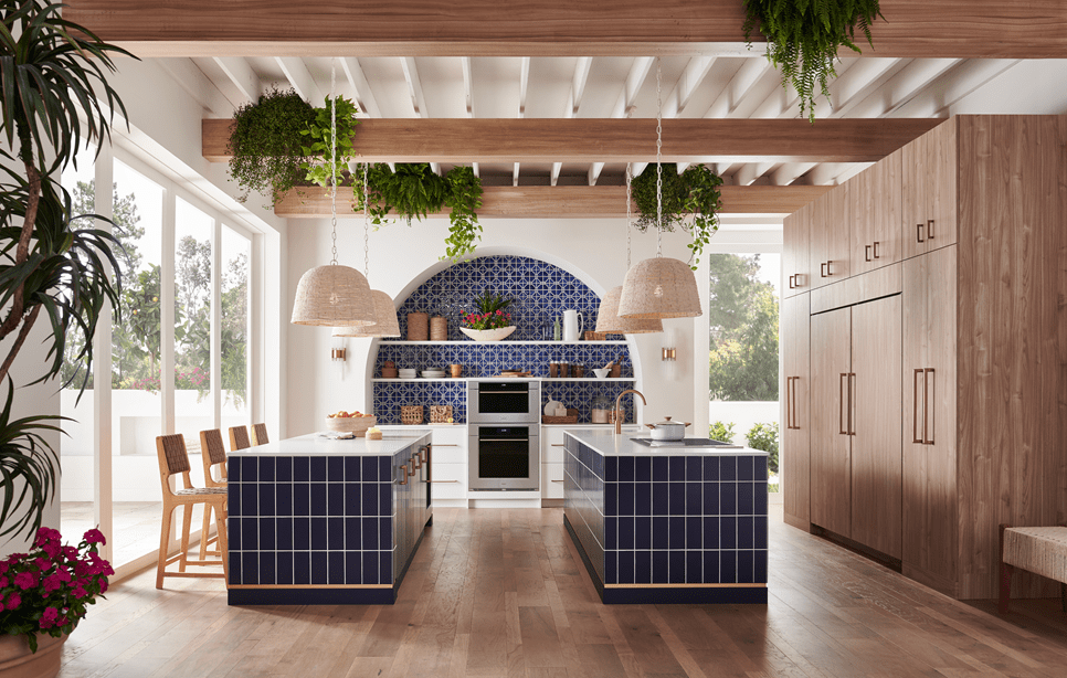 Wolf 30 Inch M Series Transitional Convection Steam Oven displayed in a Mediterranean kitchen design featuring double island, custom blue tile backsplash and exposed wood beam ceiling